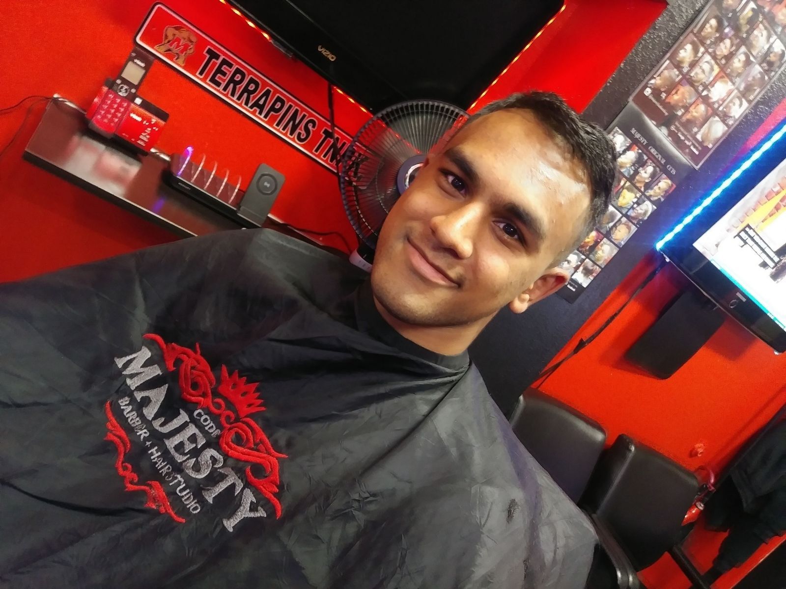 portrait young black man being trimmed