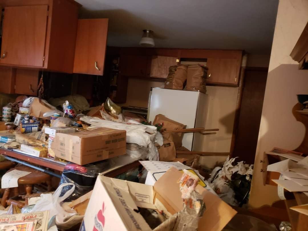 A kitchen with a lot of boxes on the floor