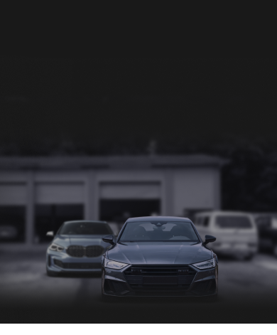 2 cars in front of repair shop | Evolution Motors