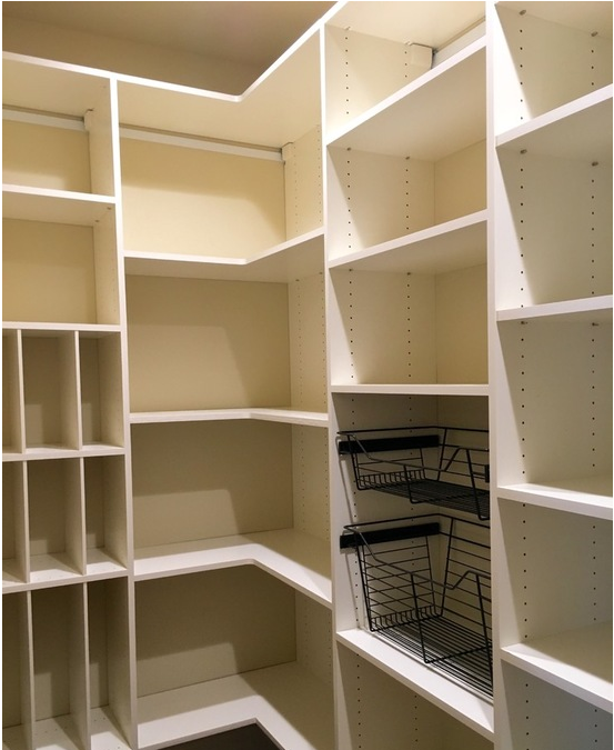 a walk in closet with lots of shelves and baskets