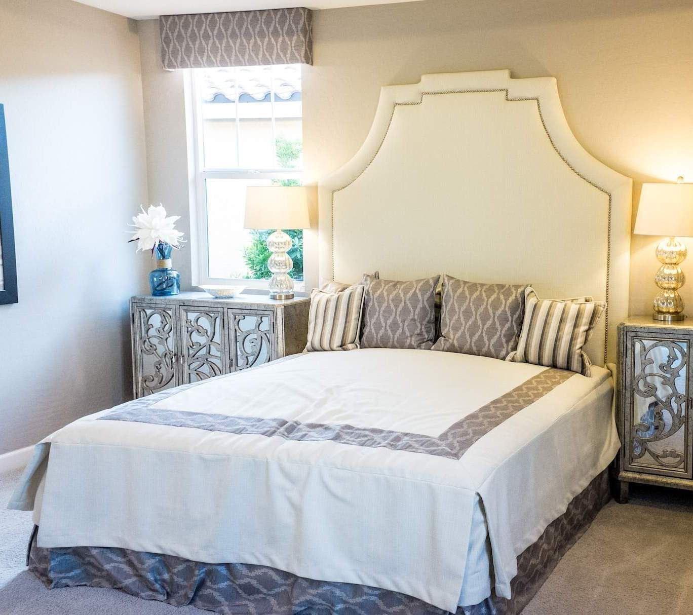 a bedroom with a large bed and two nightstands