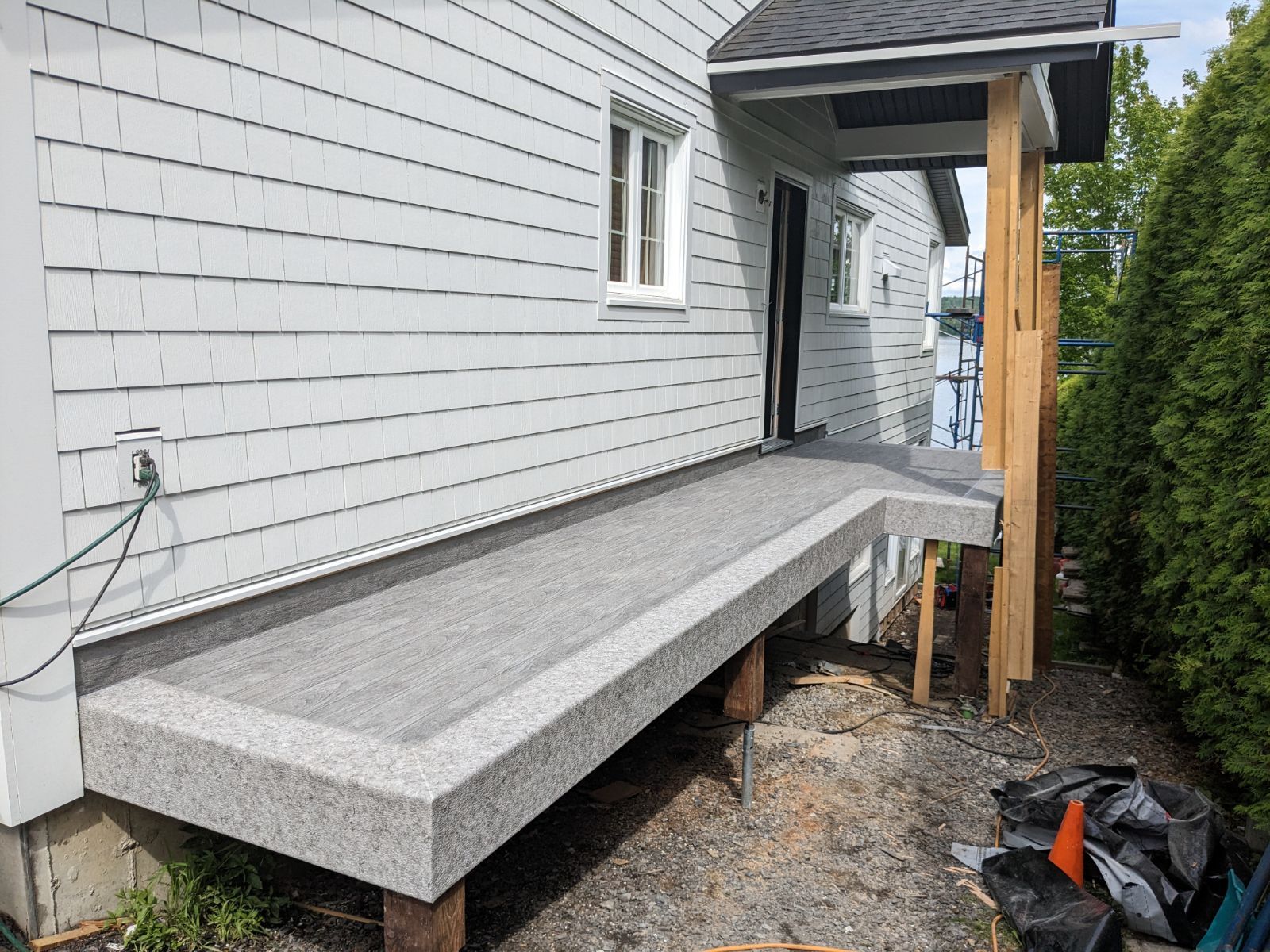 Une passerelle en PVC est en cours de construction sur le côté d'une maison.