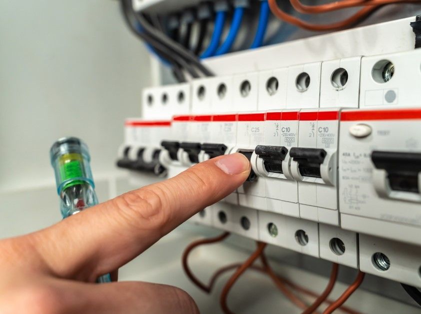 an electrician testing a new consumer unit fuse box in Derby