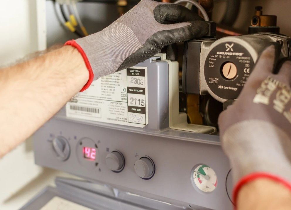 Central heating engineer carrying out a boiler service in Derby