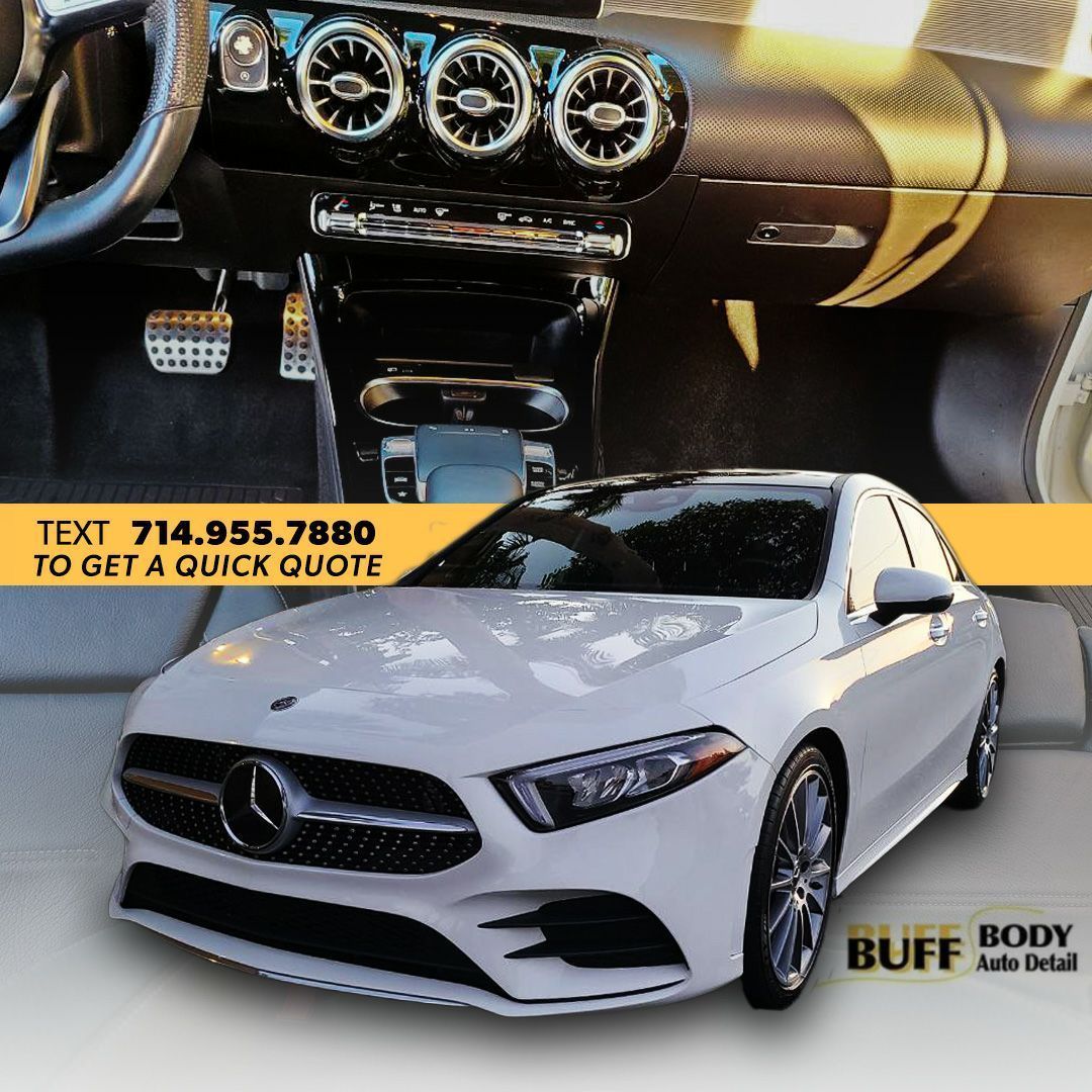 A picture of a white car with a phone number to get a quick quote