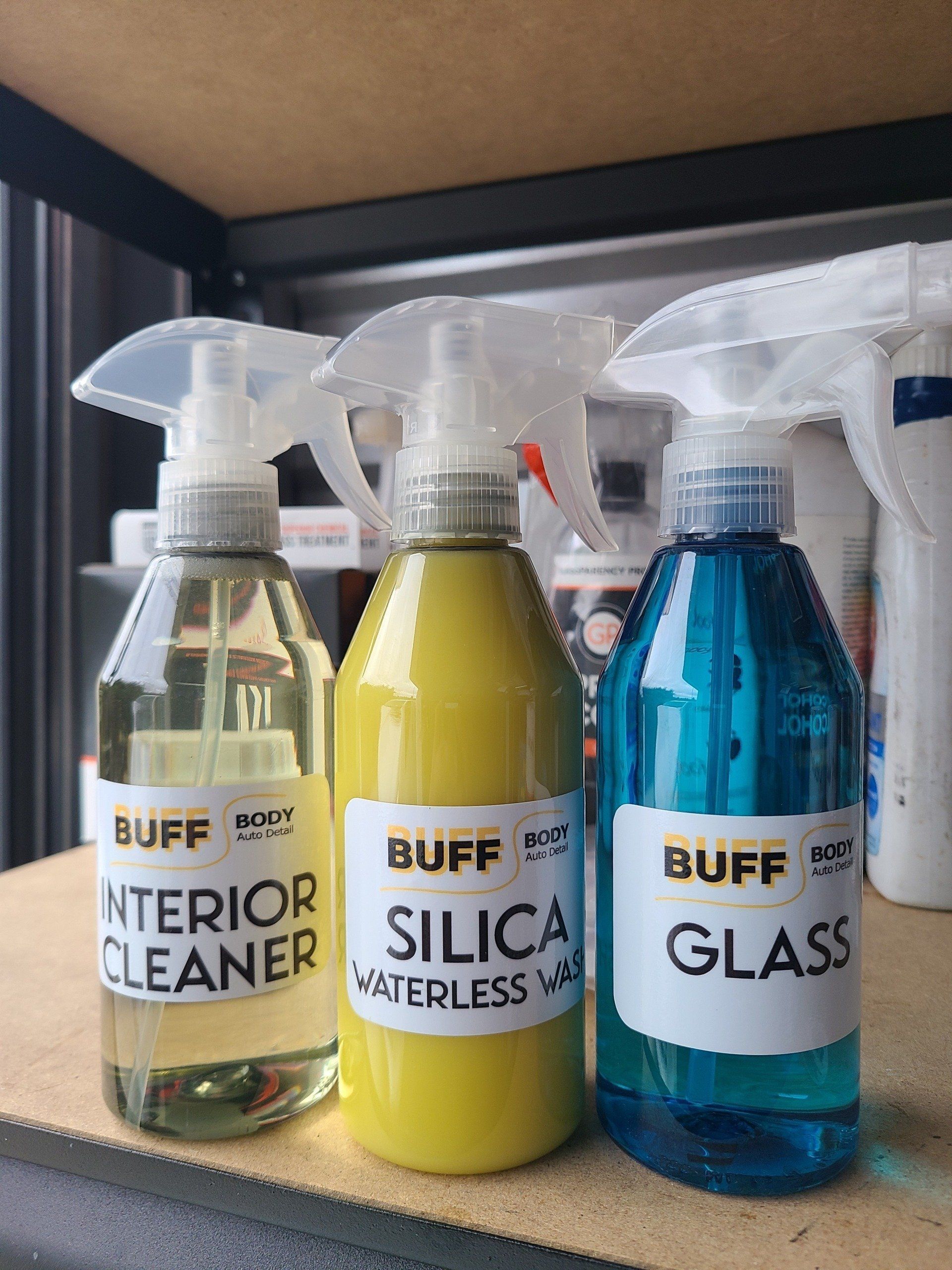 Three bottles of buff interior cleaner sit on a shelf