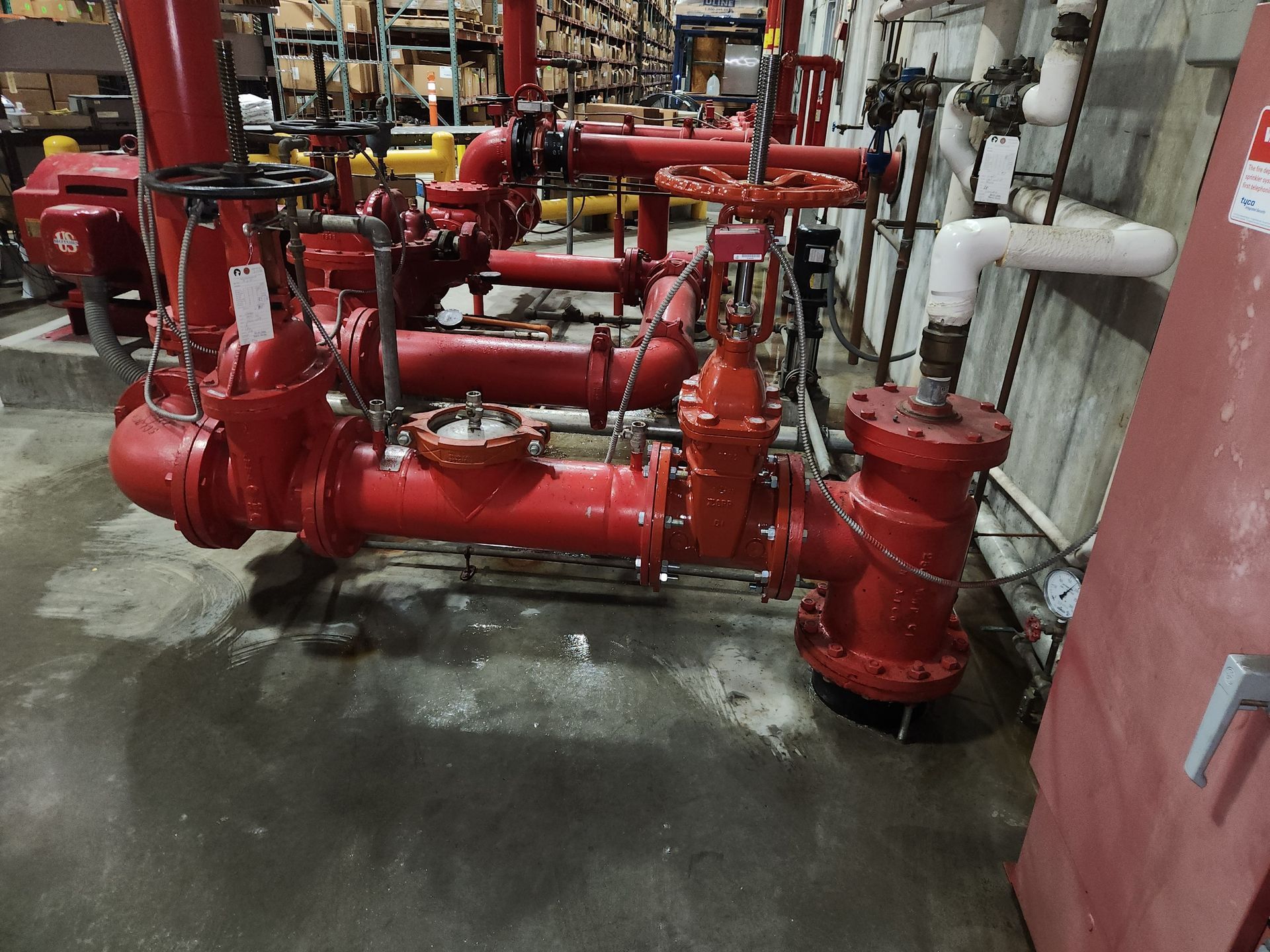 A warehouse filled with lots of red pipes and valves