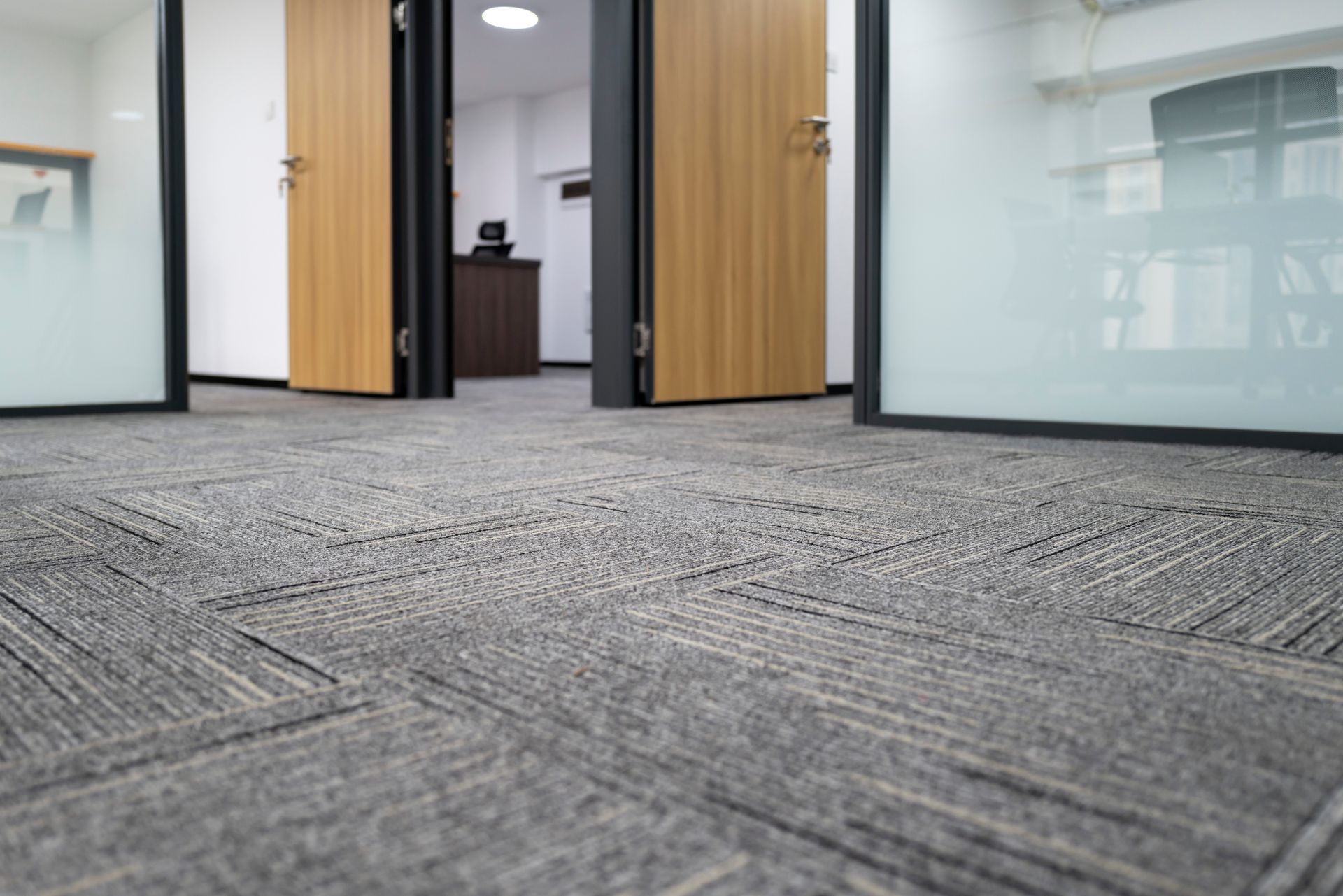 A close up of a carpeted floor in an office.