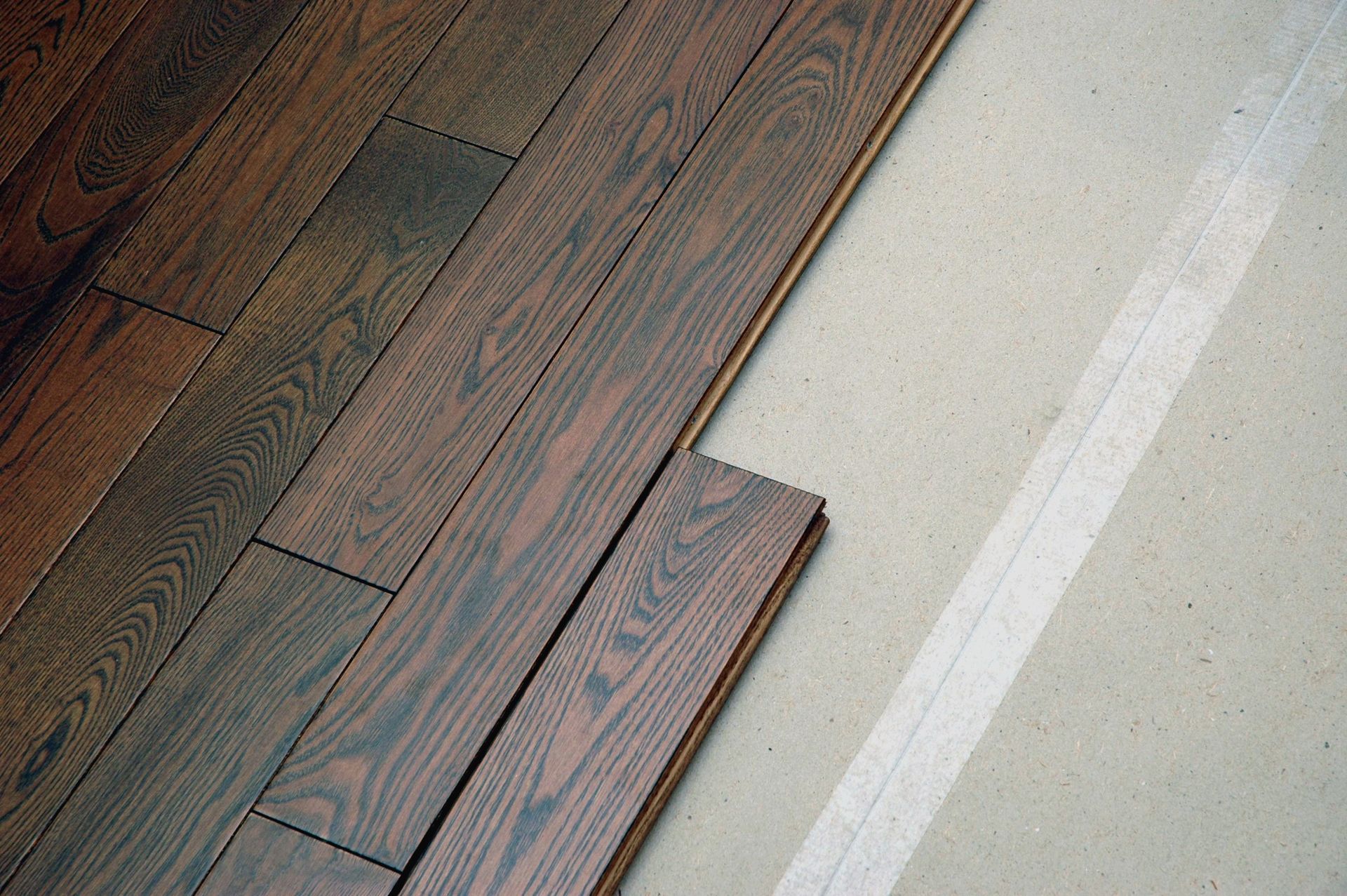 A wooden floor with a white line on it