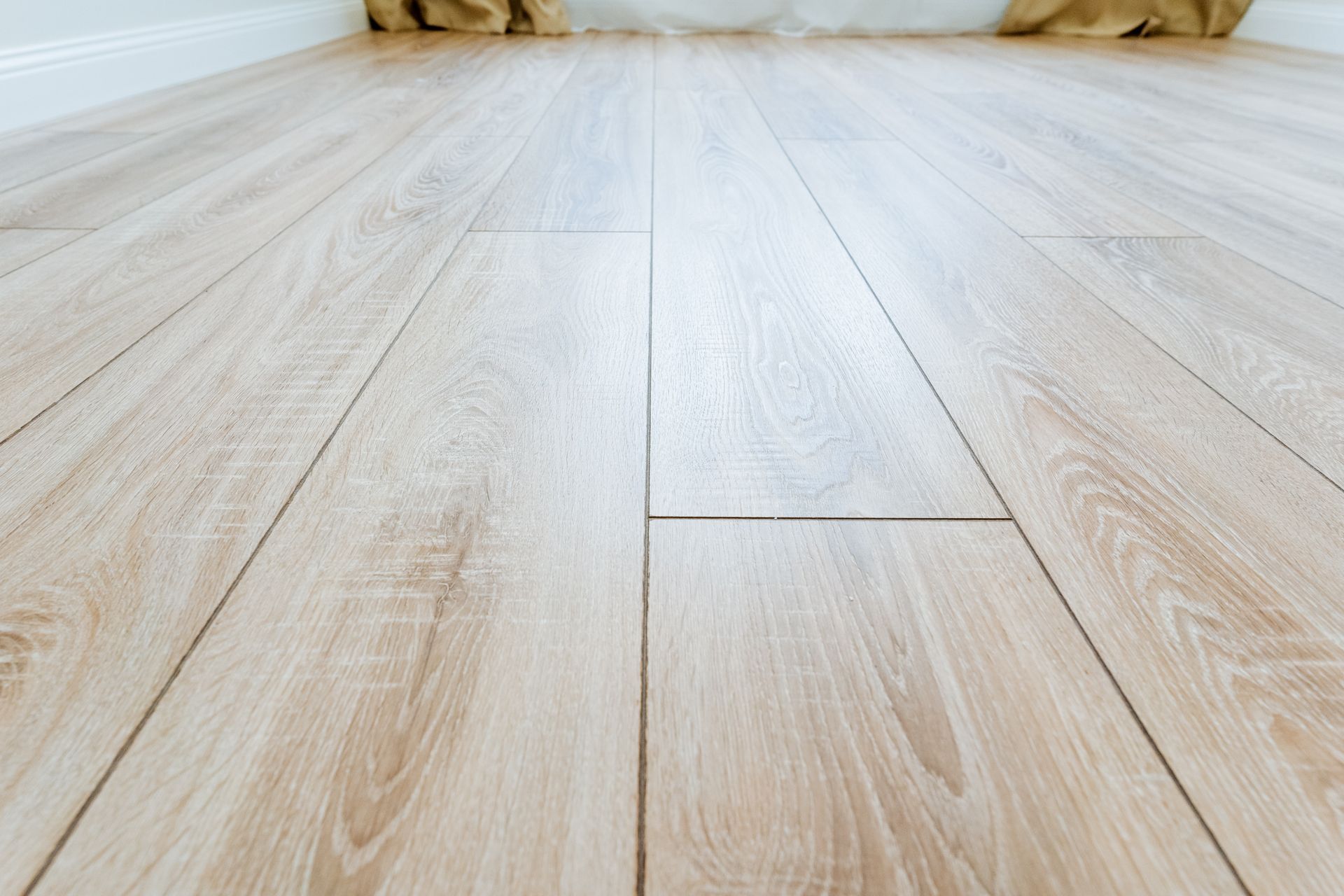 A close up of a wooden floor in a room.