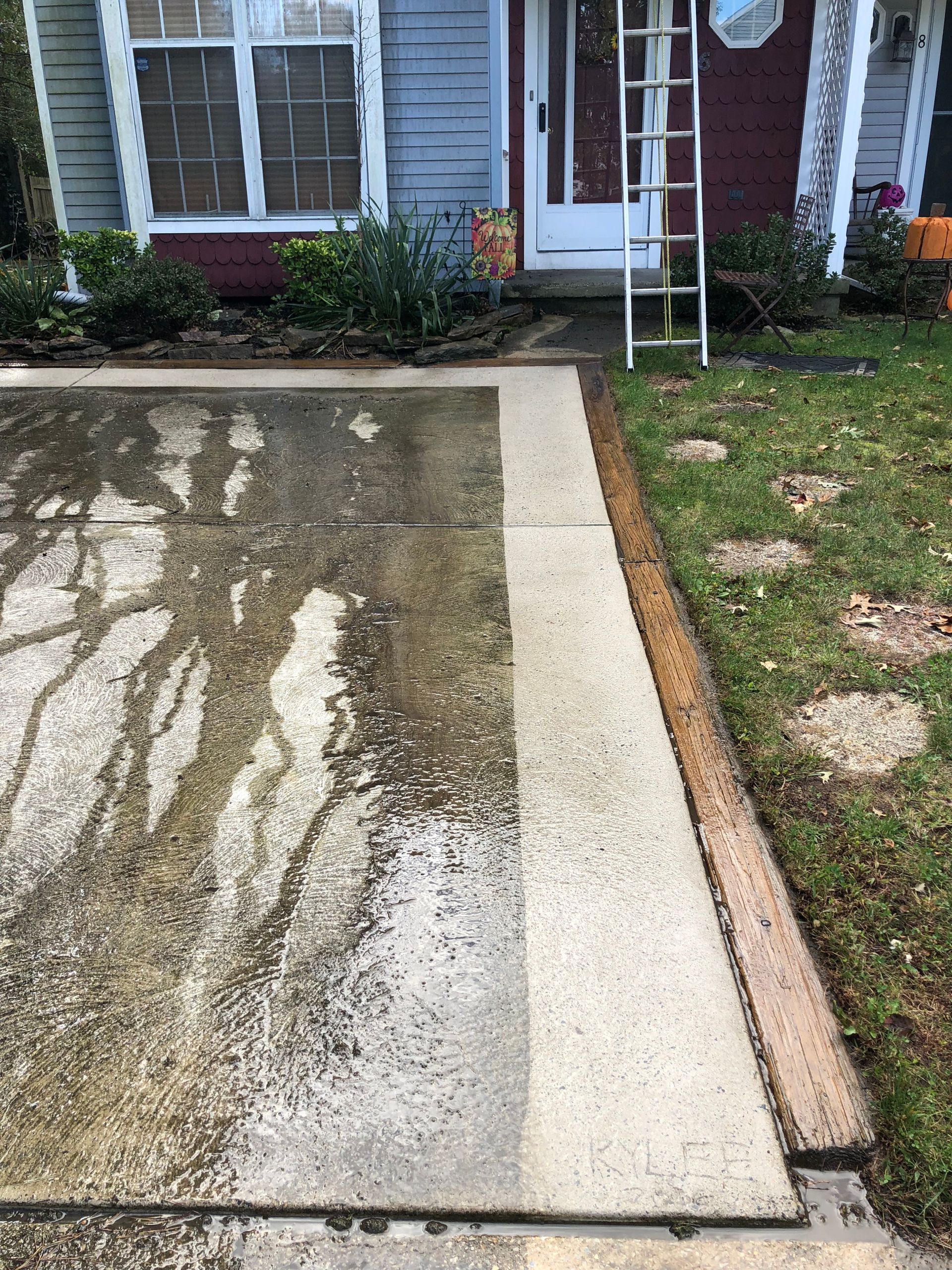 Concrete walkway, half cleaned, shows before and after with water stain done by Melo Powerwashing & Painting in somers point, nj