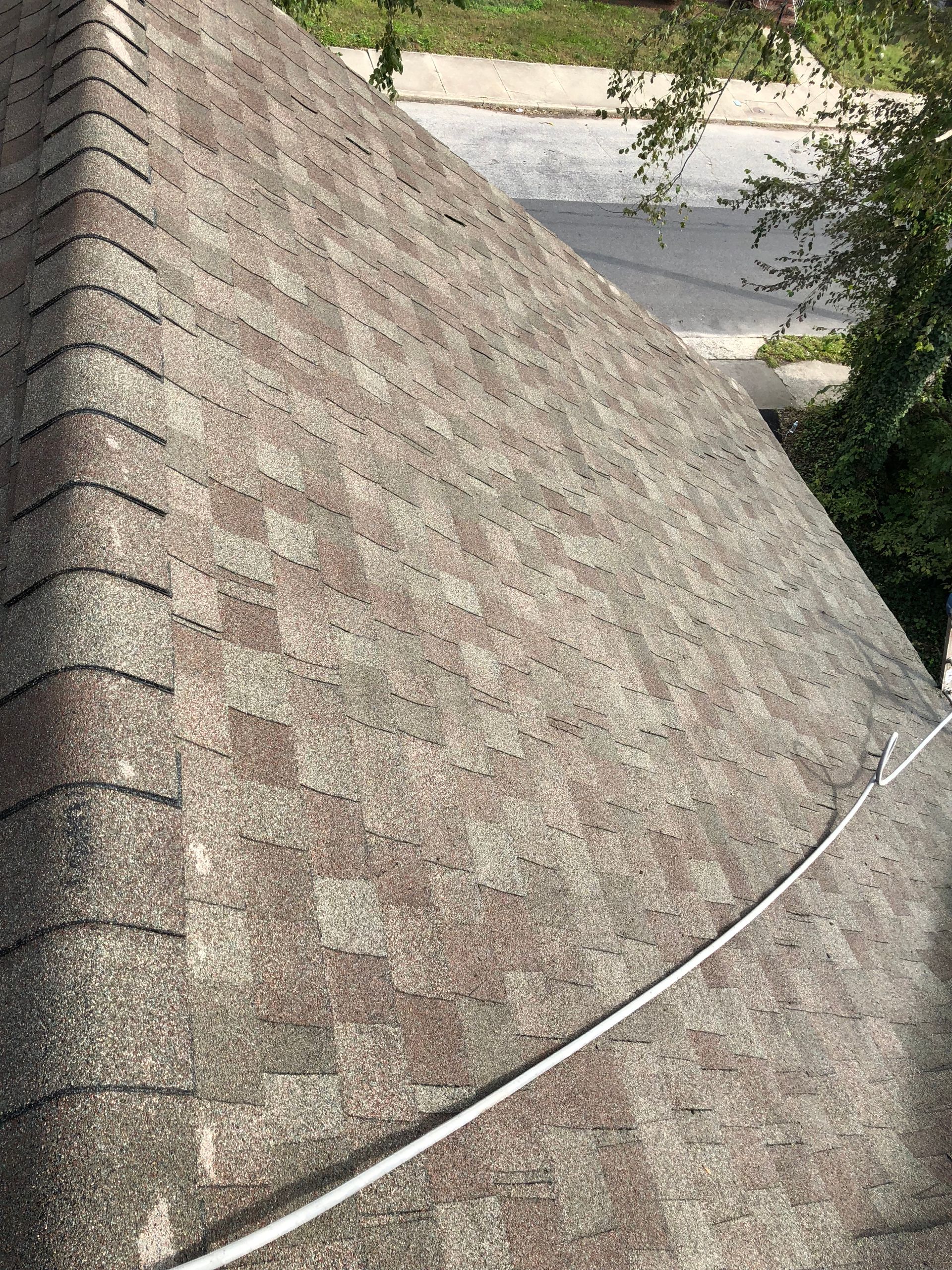 A close up of a roof with a wire hanging from it