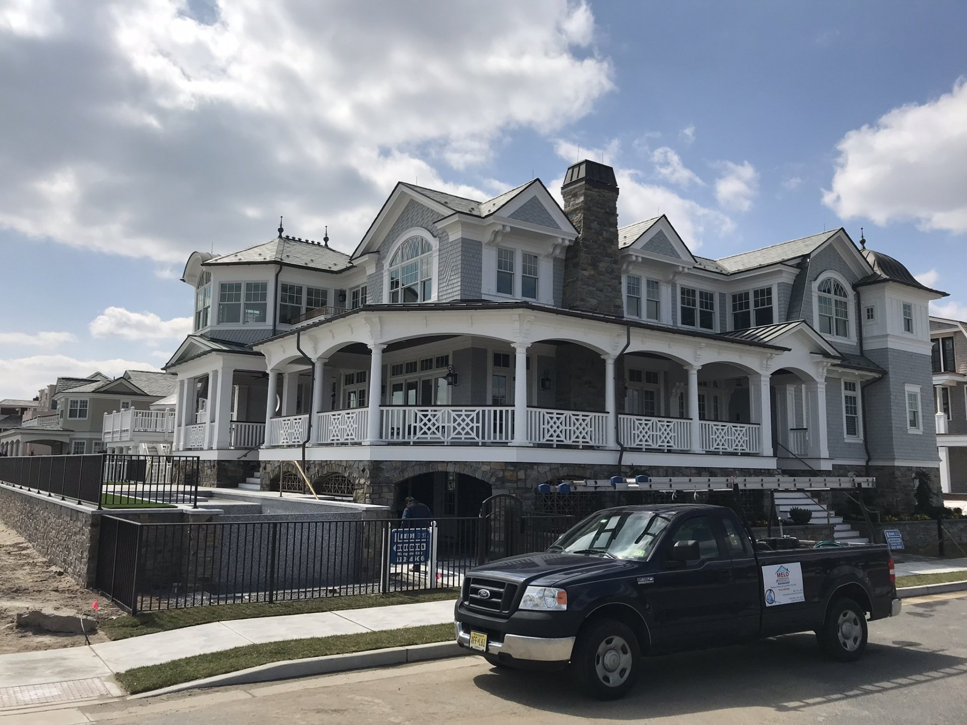 melo powerwashing and painting company truck sitting in front of house on the beach