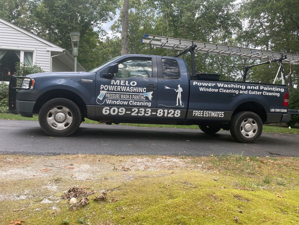 melo powerwashing and painting company truck sitting in driveway