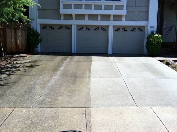 melo powerwashing employee pressure washing a brick colored patio