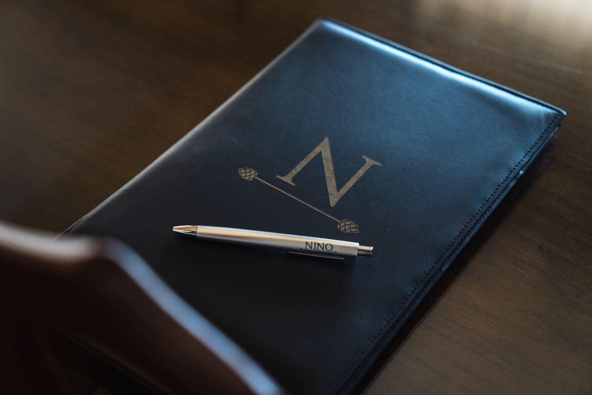 Una carpeta de cuero negro con la letra 