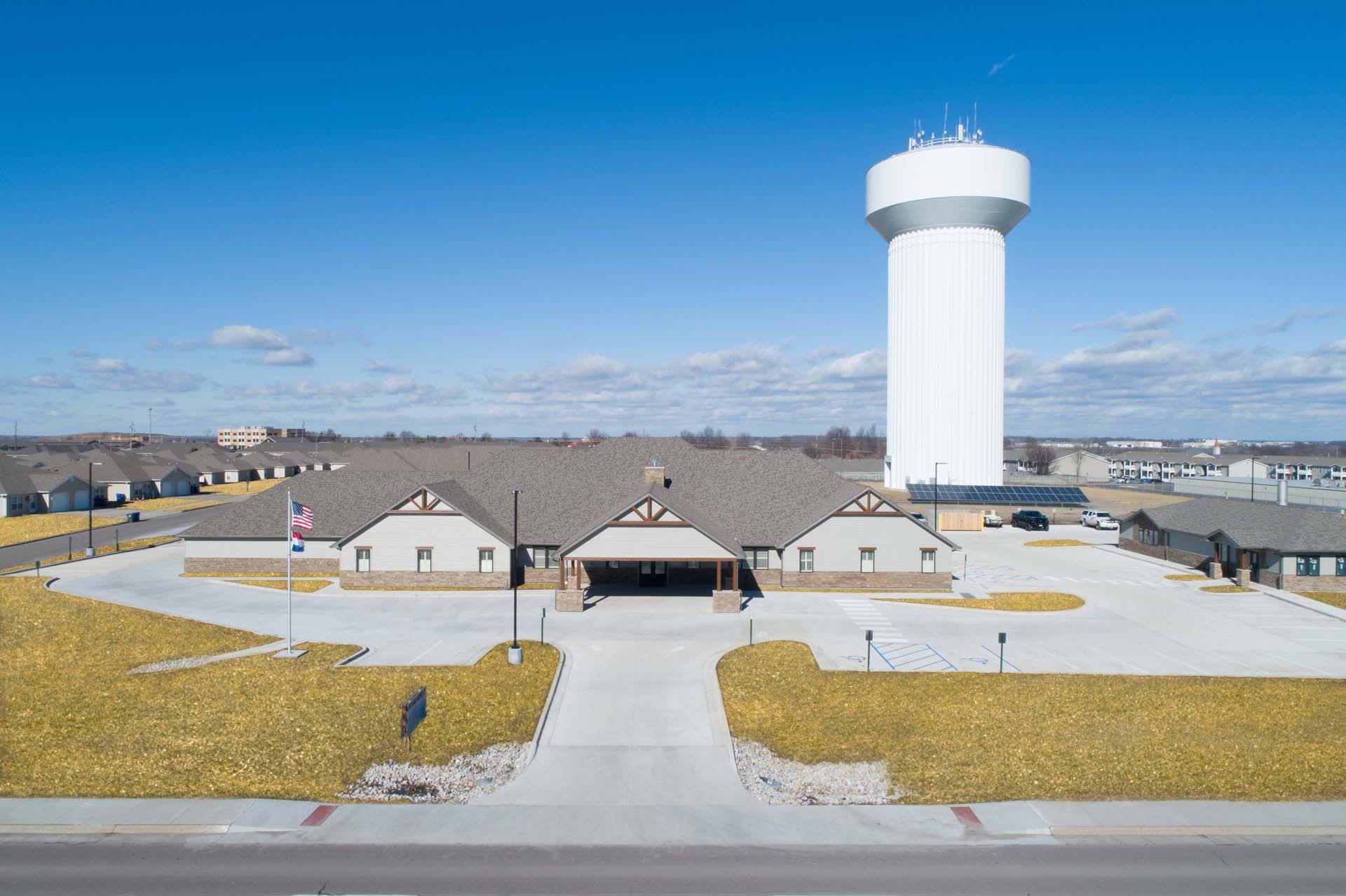 an aerial view of a funeral home with a water tower in the background .