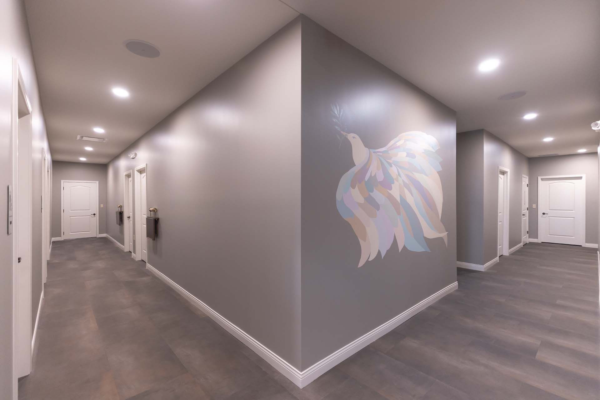 a long hallway with a painting on the wall