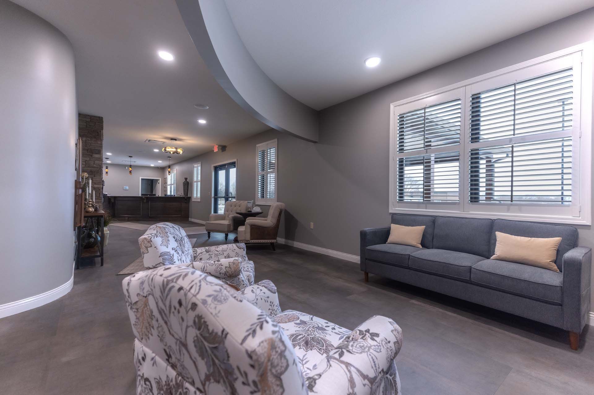 a living room with a couch and chairs in it