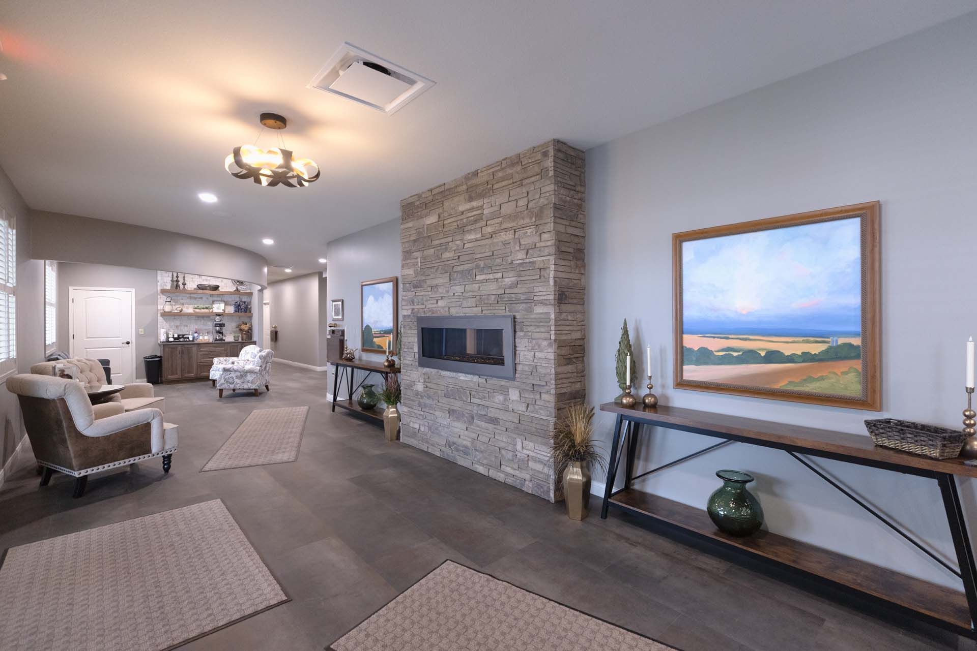 a living room with a fireplace and a television on the wall .