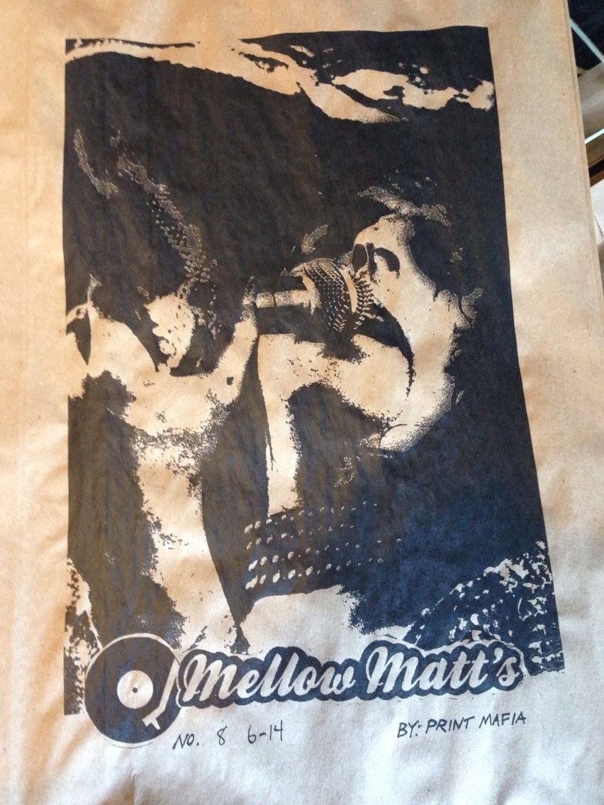 Tote bag with a black and white image of a person singing into a microphone; text: 