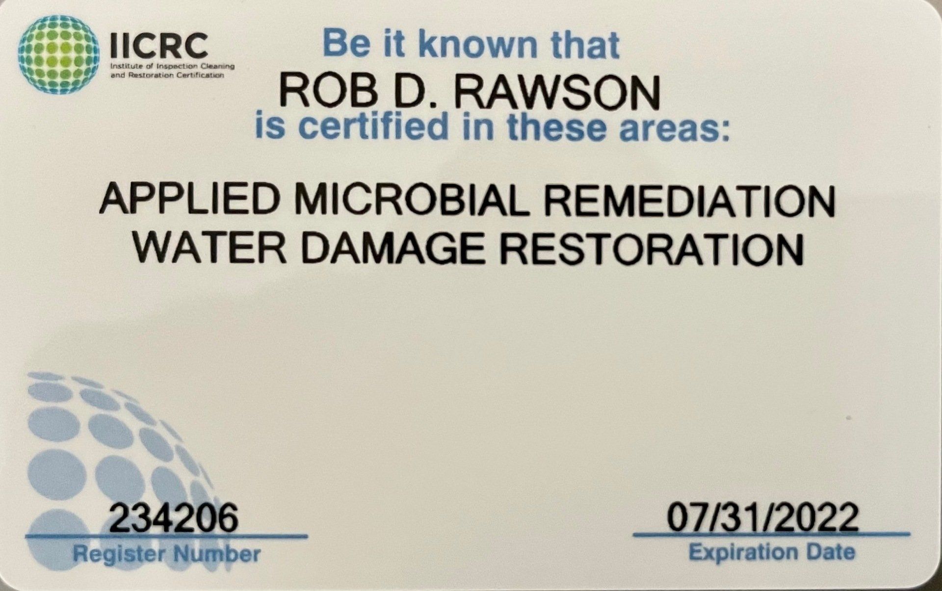 A white card that says applied microbial remediation water damage restoration