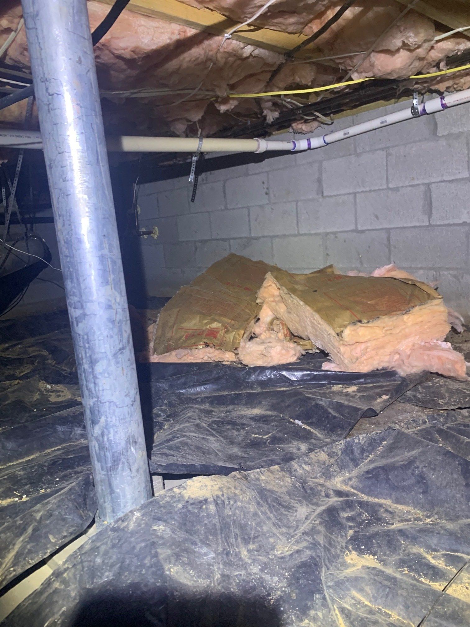 There is a lot of insulation in the basement of a house.