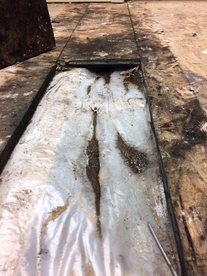 There is a hole in the floor that looks like a drain.