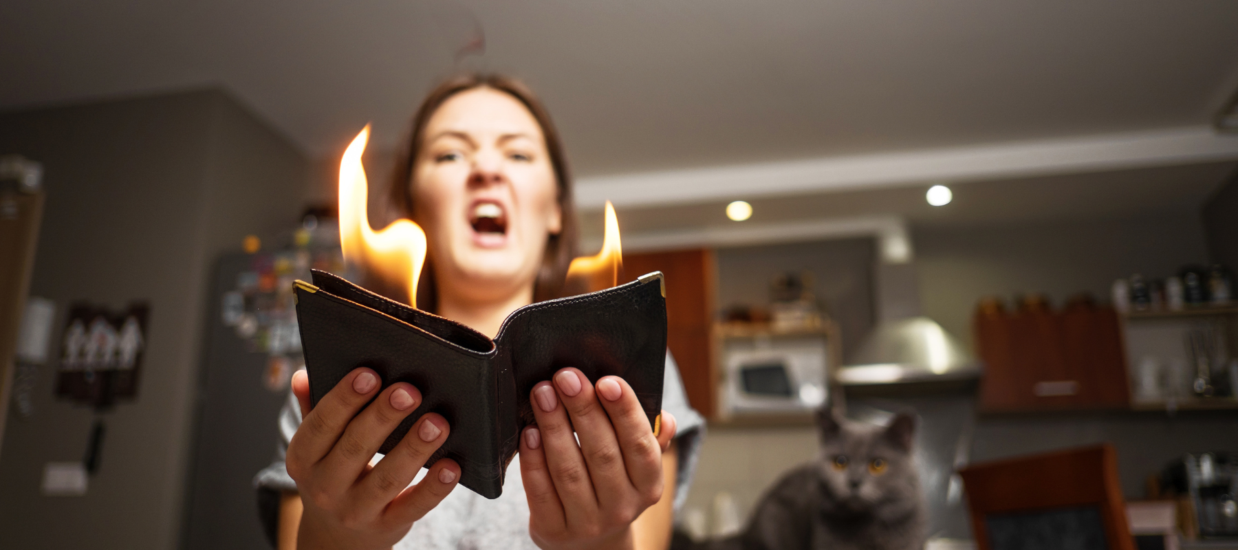 A woman holding a book with flames coming out of it