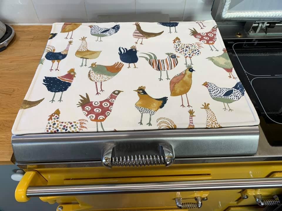 A stove top oven with a chicken pattern on it.
