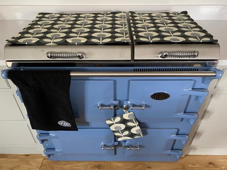 A blue stove with a black towel on it