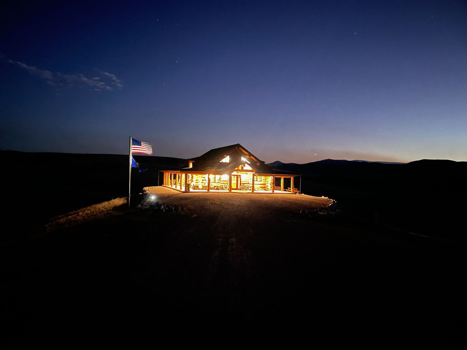 The Outpost at ElkView flag at night
