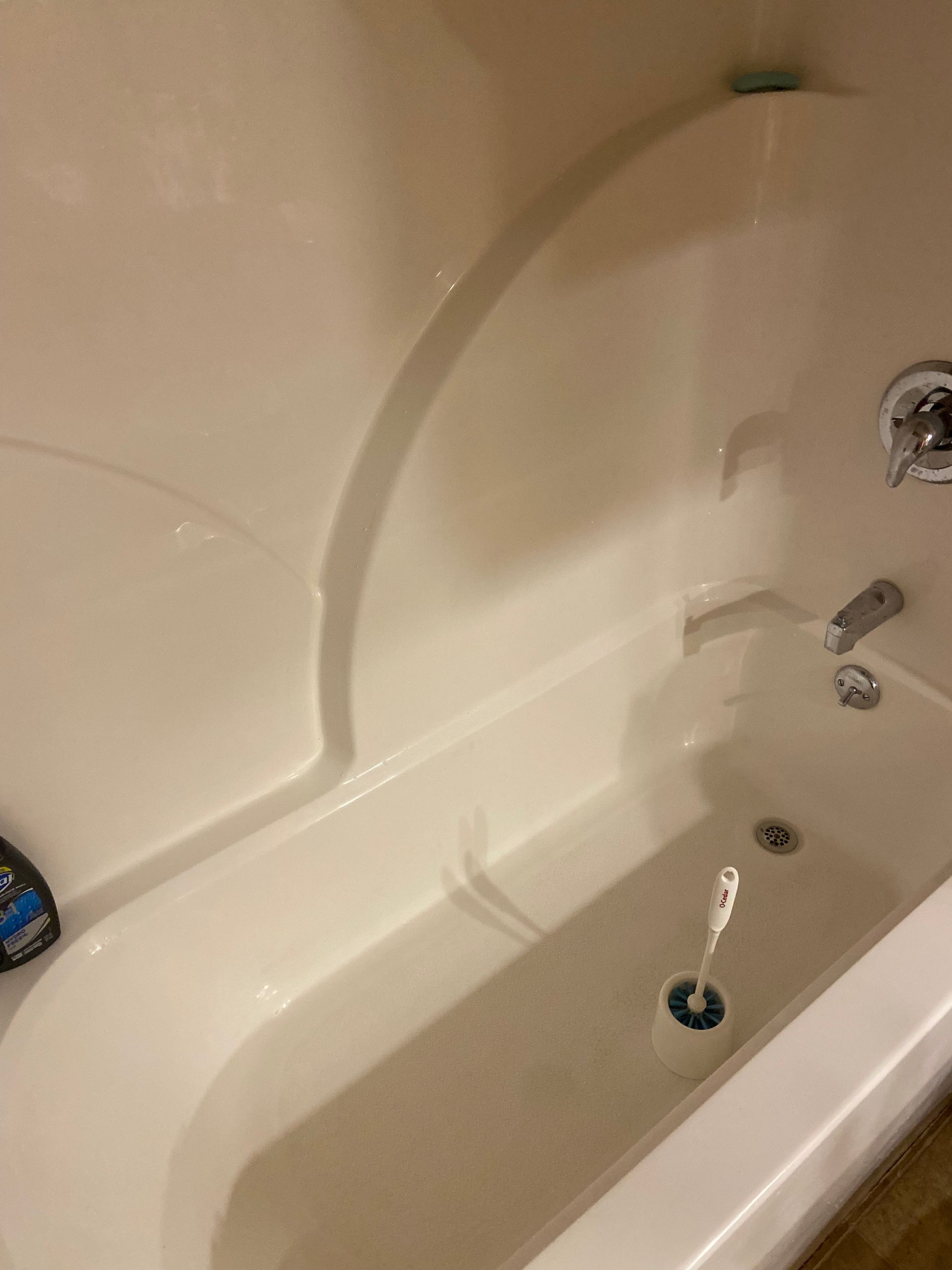 A bathtub with water coming out of the drain.