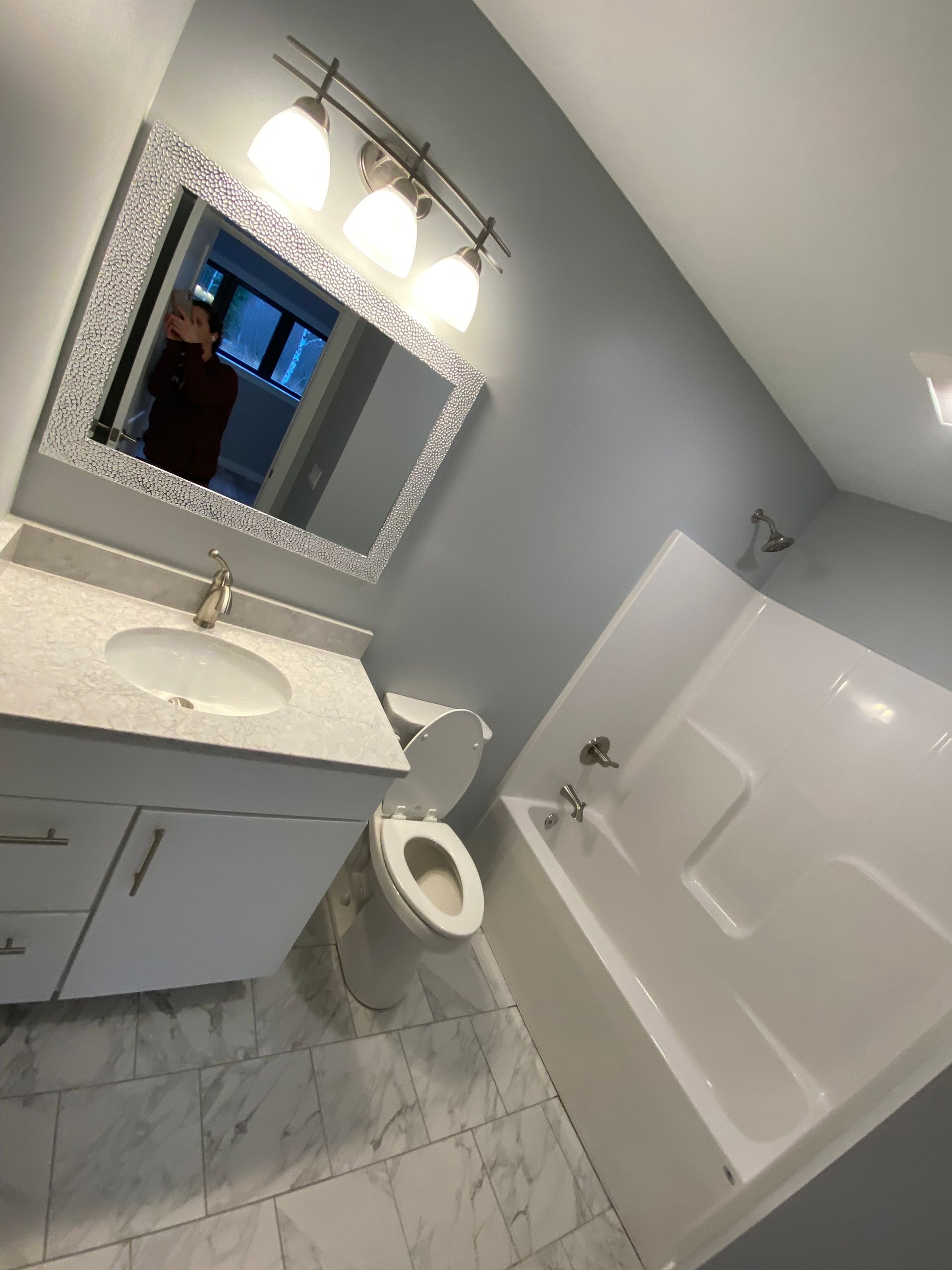 A bathroom with a toilet a sink and a bathtub
