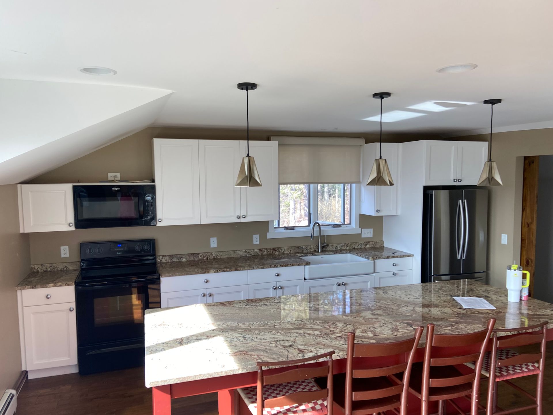 A kitchen with white cabinets and granite counter tops