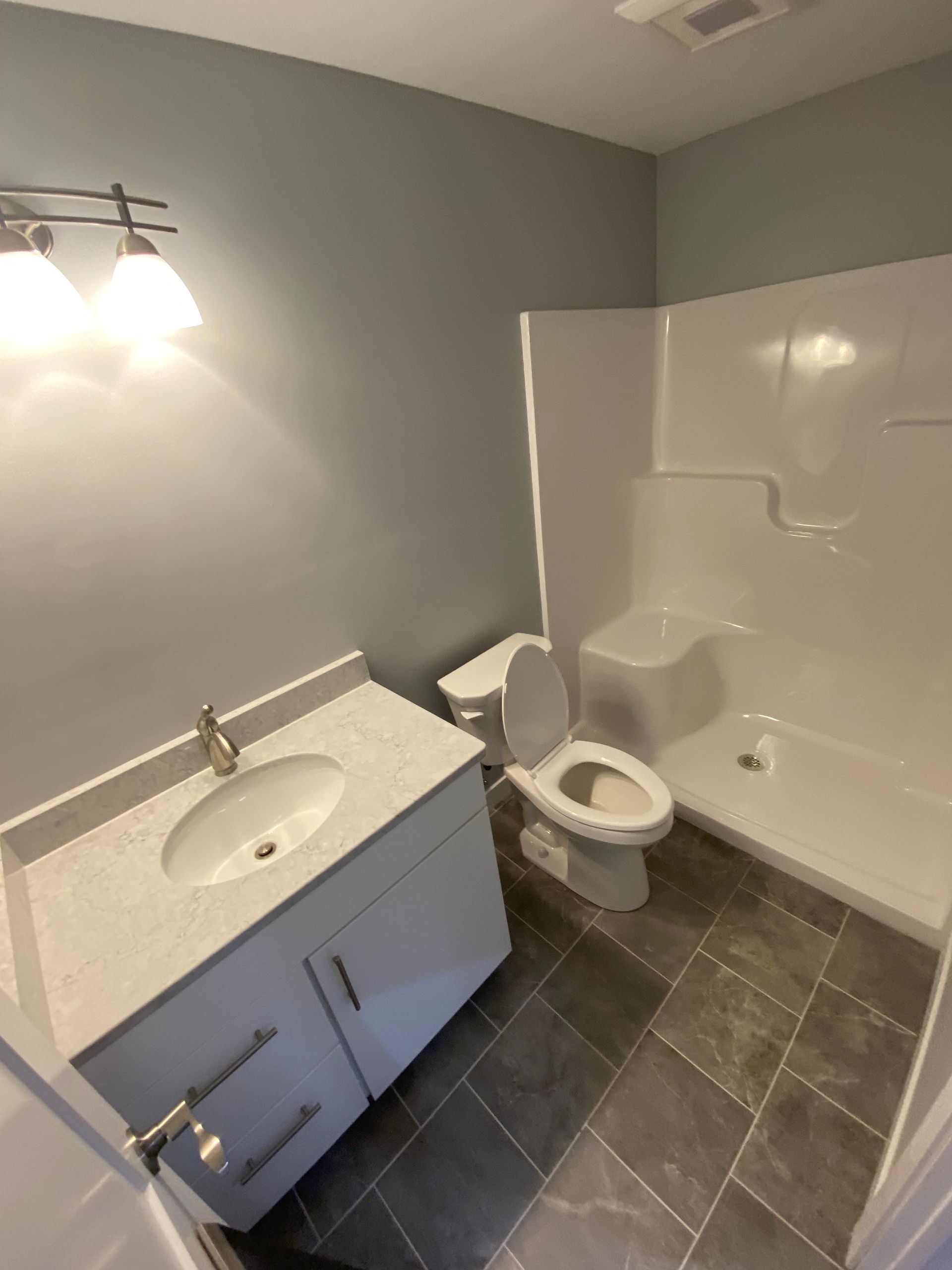 A bathroom with a sink toilet and shower