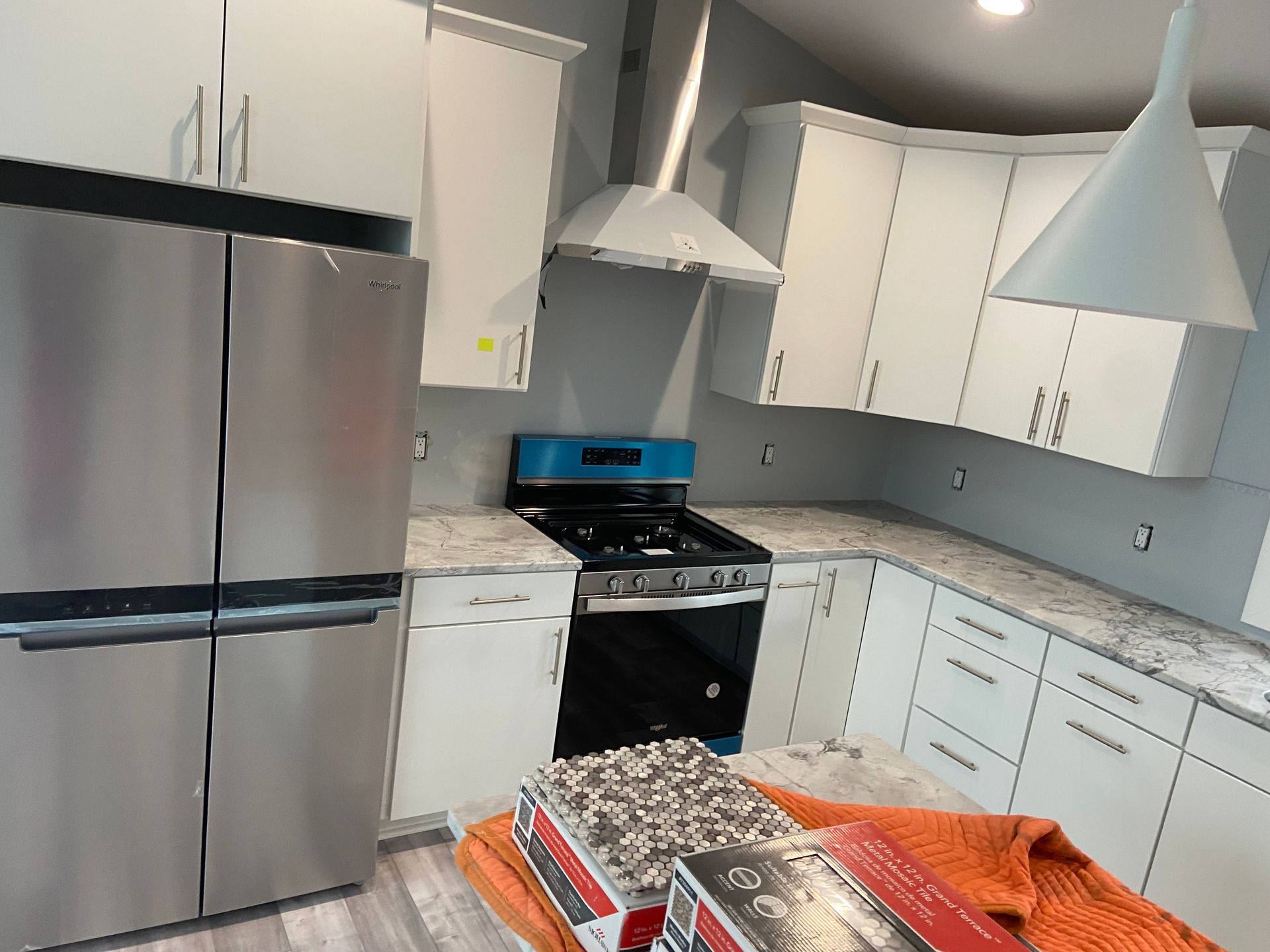 A kitchen with stainless steel appliances and white cabinets