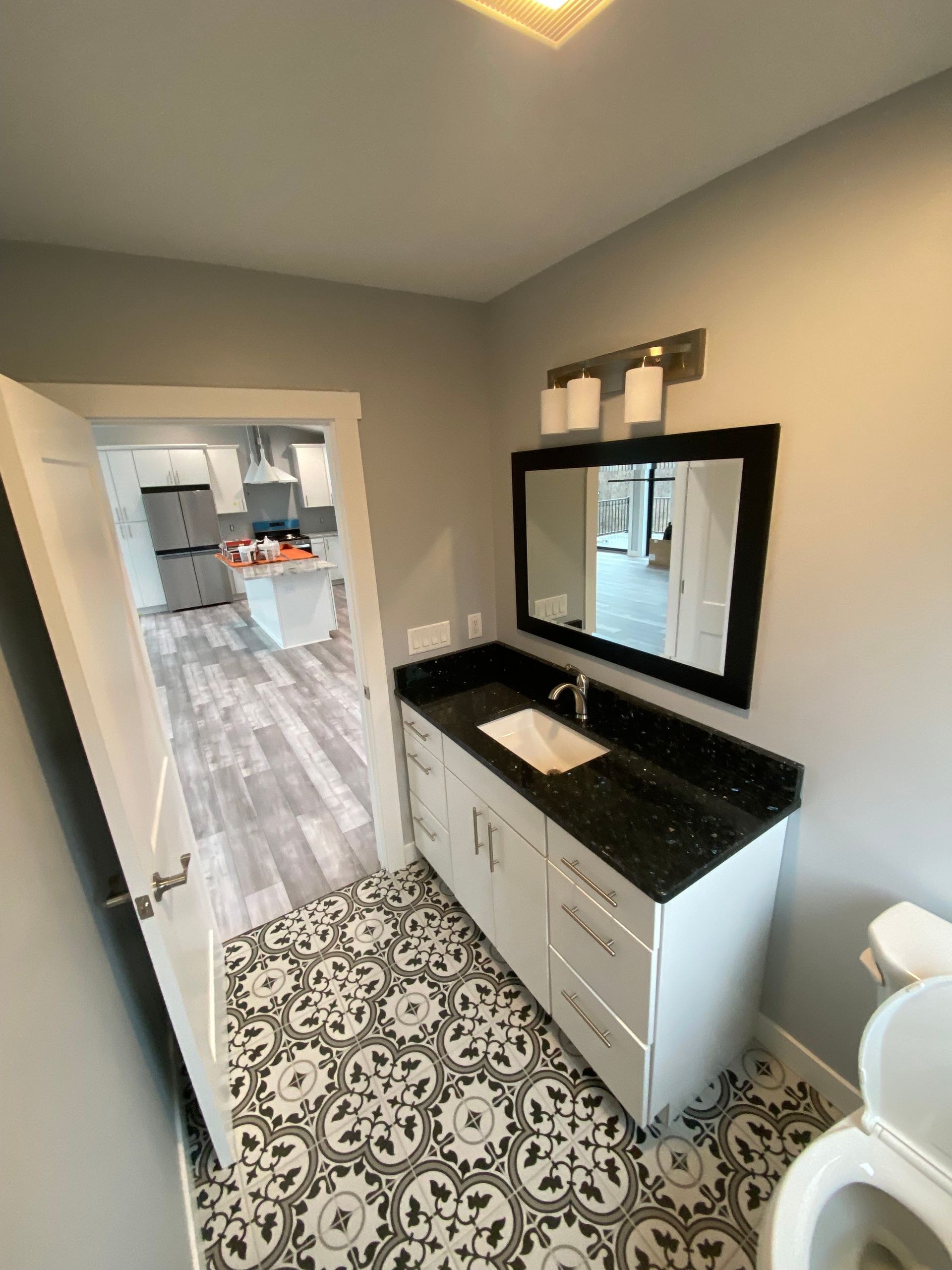 A bathroom with a sink , mirror and toilet.