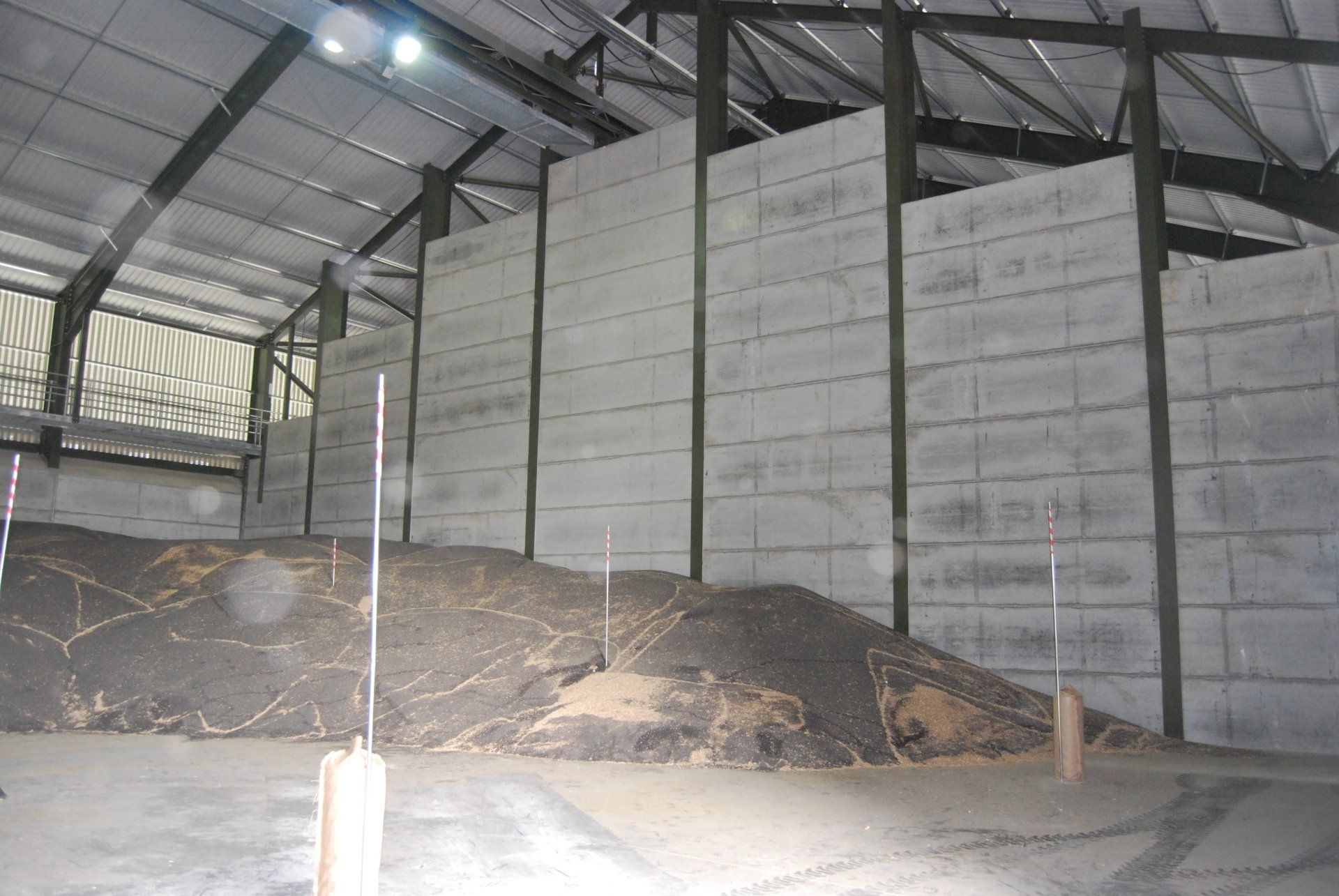 A warehouse with a large pile of dirt in the middle