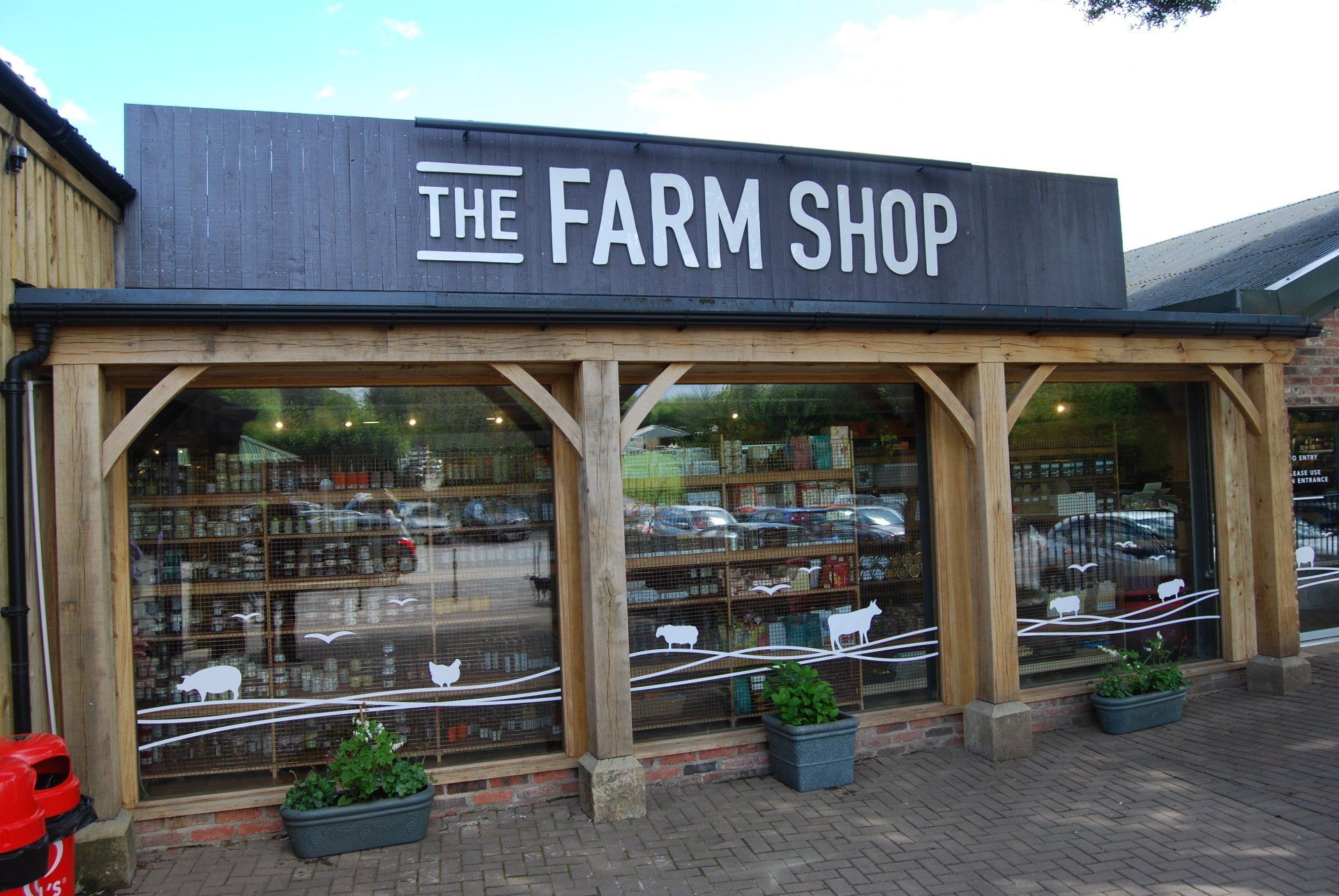 A farm shop with a large sign on the front of it.