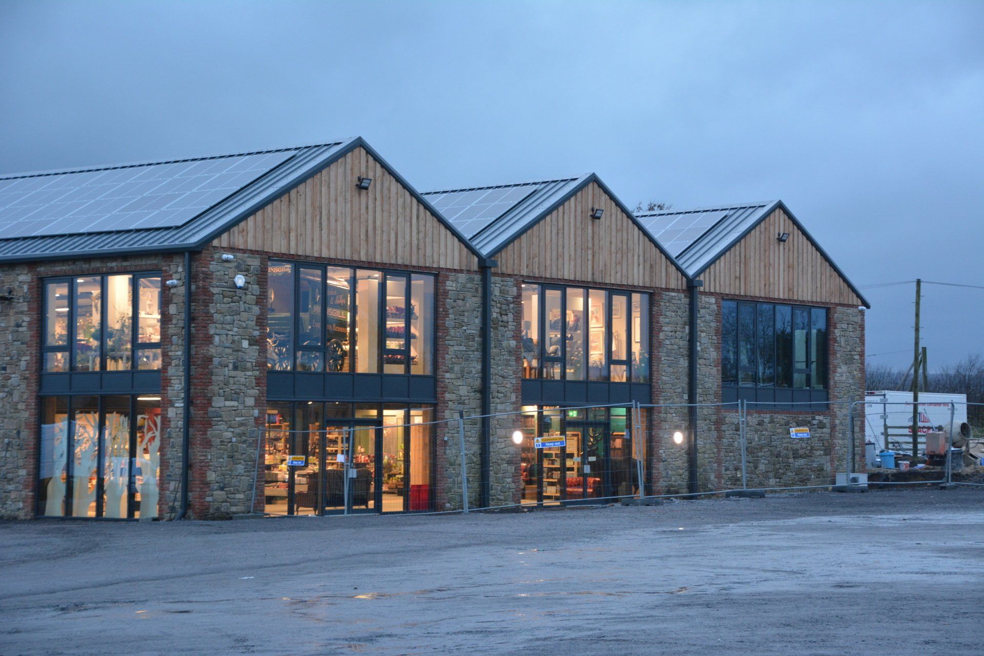 A large building with a lot of windows is lit up at night