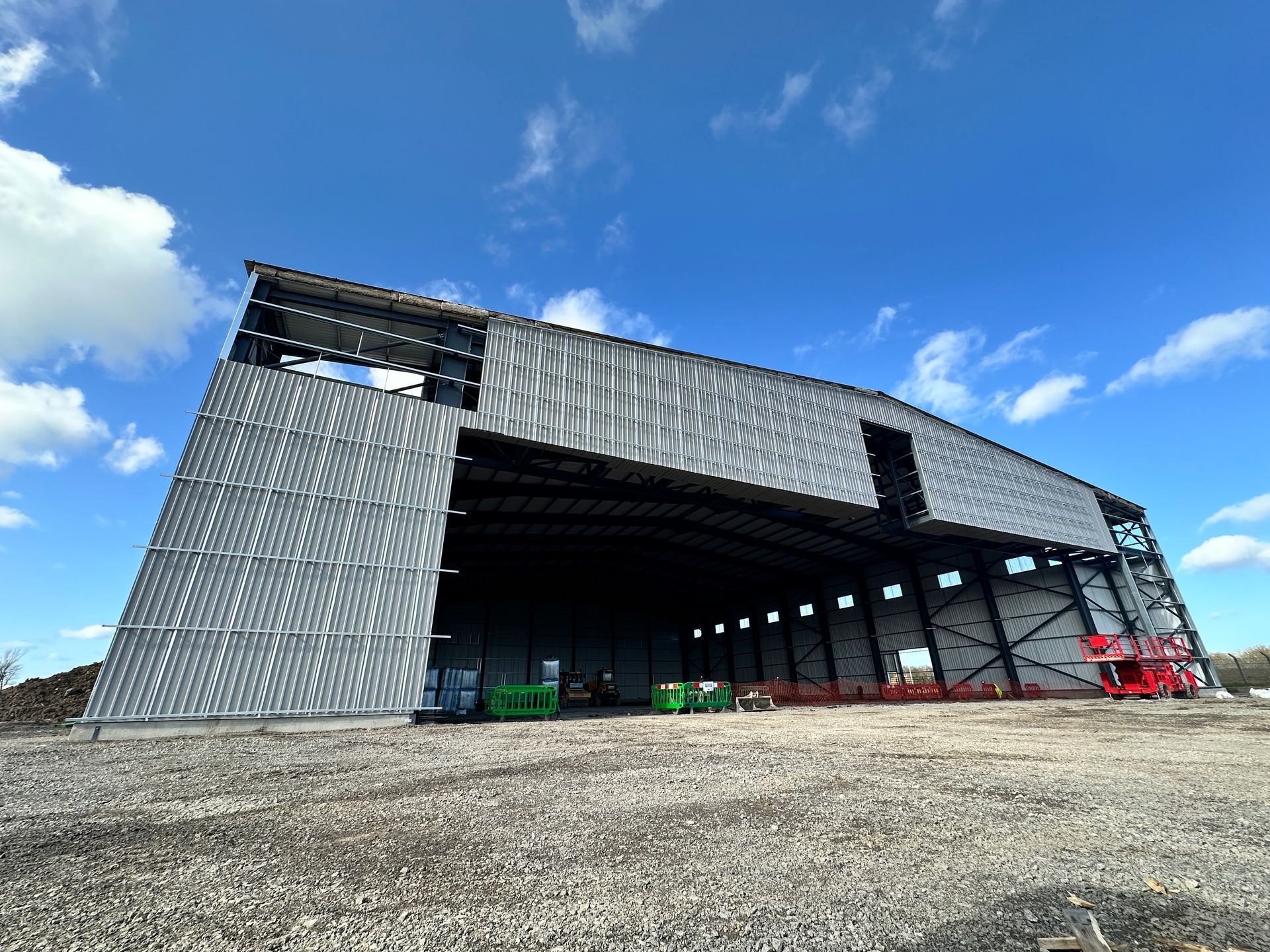 A large building under construction with a blue sky in the background.