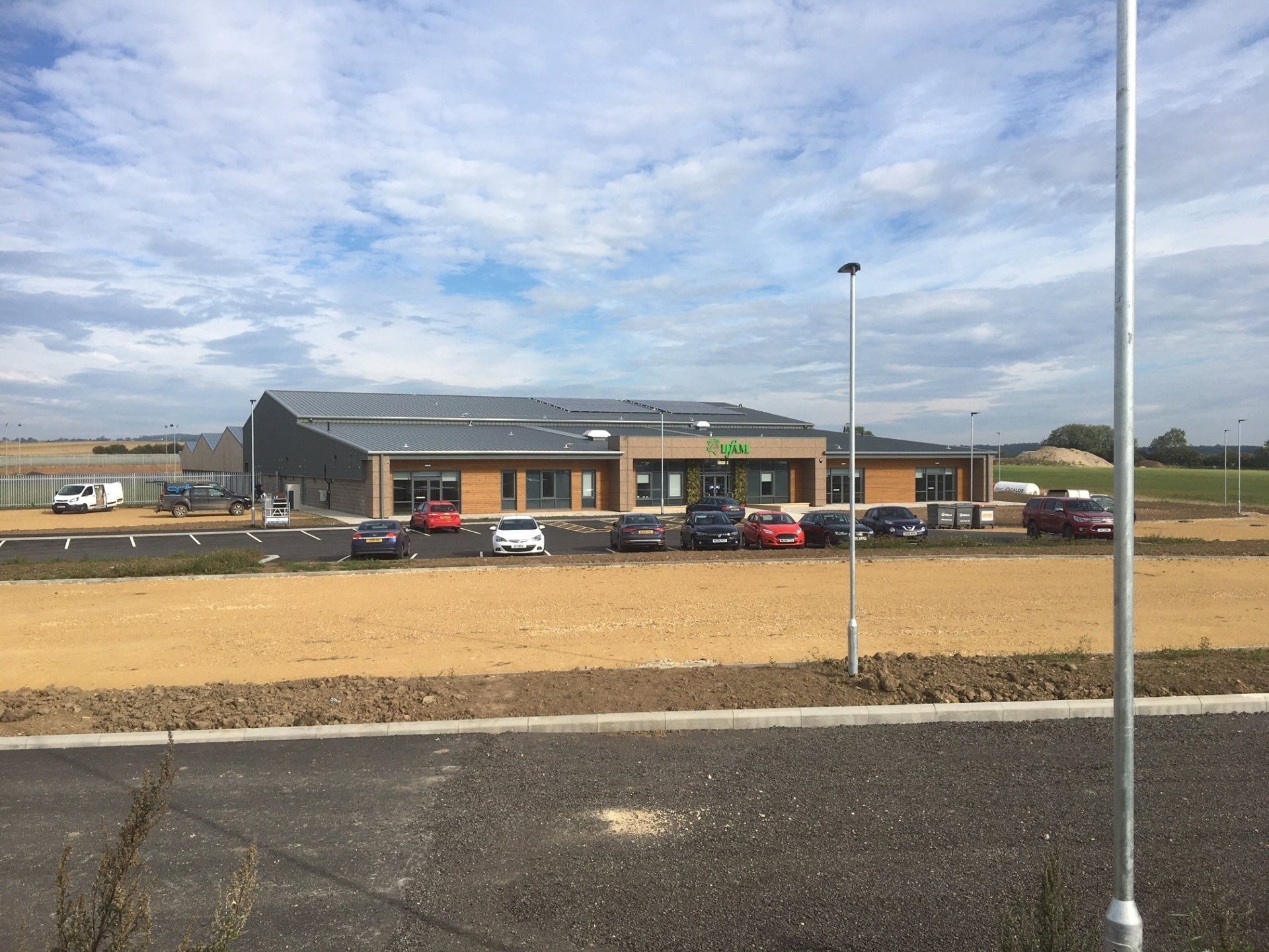 A building with a lot of cars parked in front of it