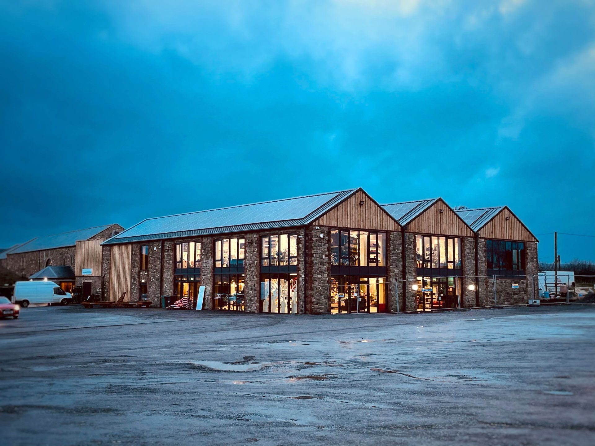 A large building with a lot of windows is lit up at night.