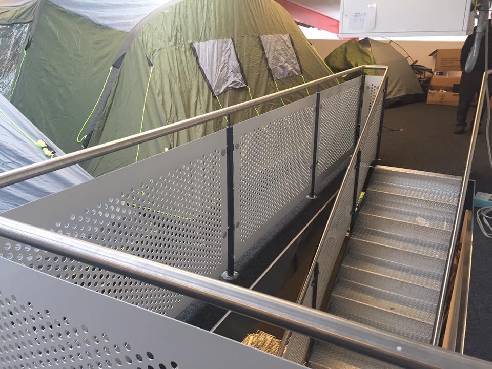A set of stairs leading up to a row of tents