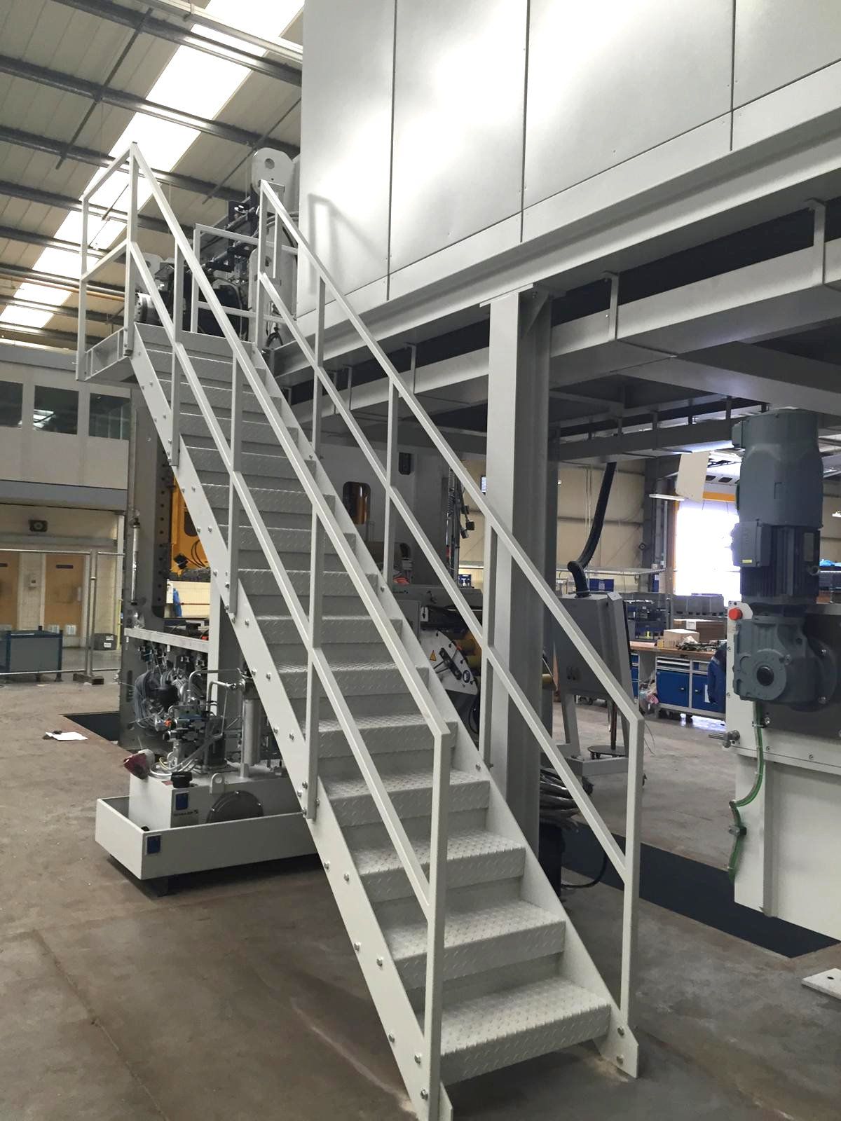 A set of stairs leading up to a machine in a factory