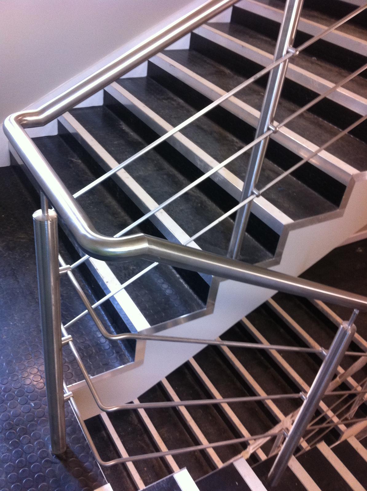 A close up of a staircase with a metal railing