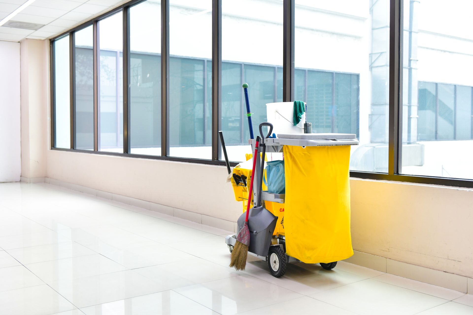 A Yellow Cleaning Cart With A Broom And Mop On It | Clinton Township, MI | Touch of Class Cleaning
