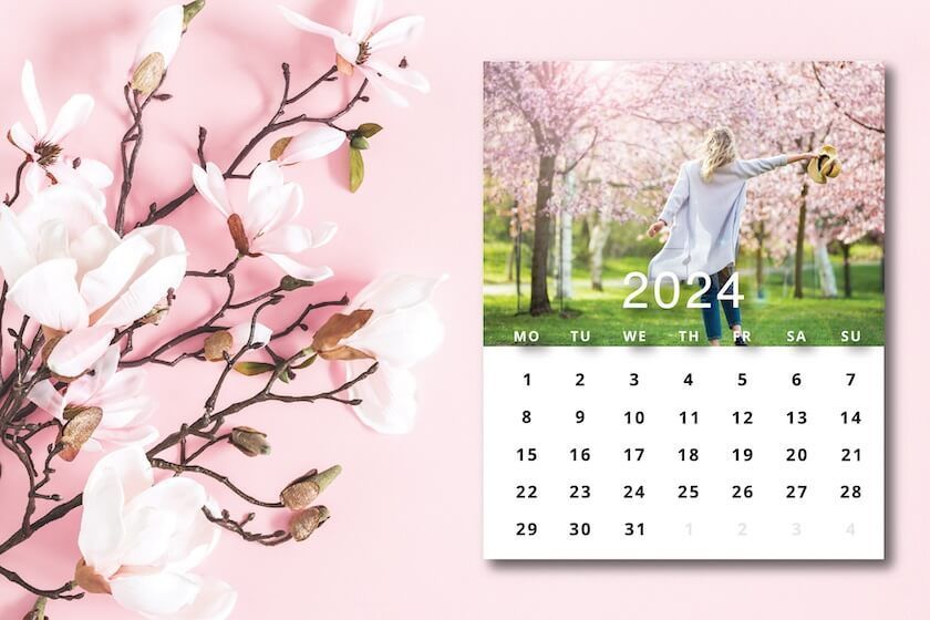 A calendar with flowers on a wooden table