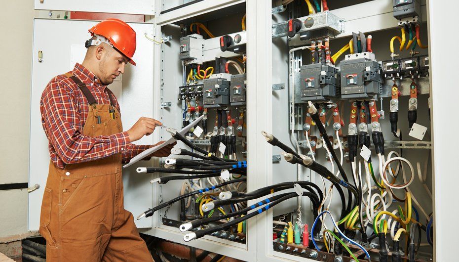 Electrician Worker With Electric Scheme Plan — Kernersville, NC — Hodges Triad Electric Co LLC